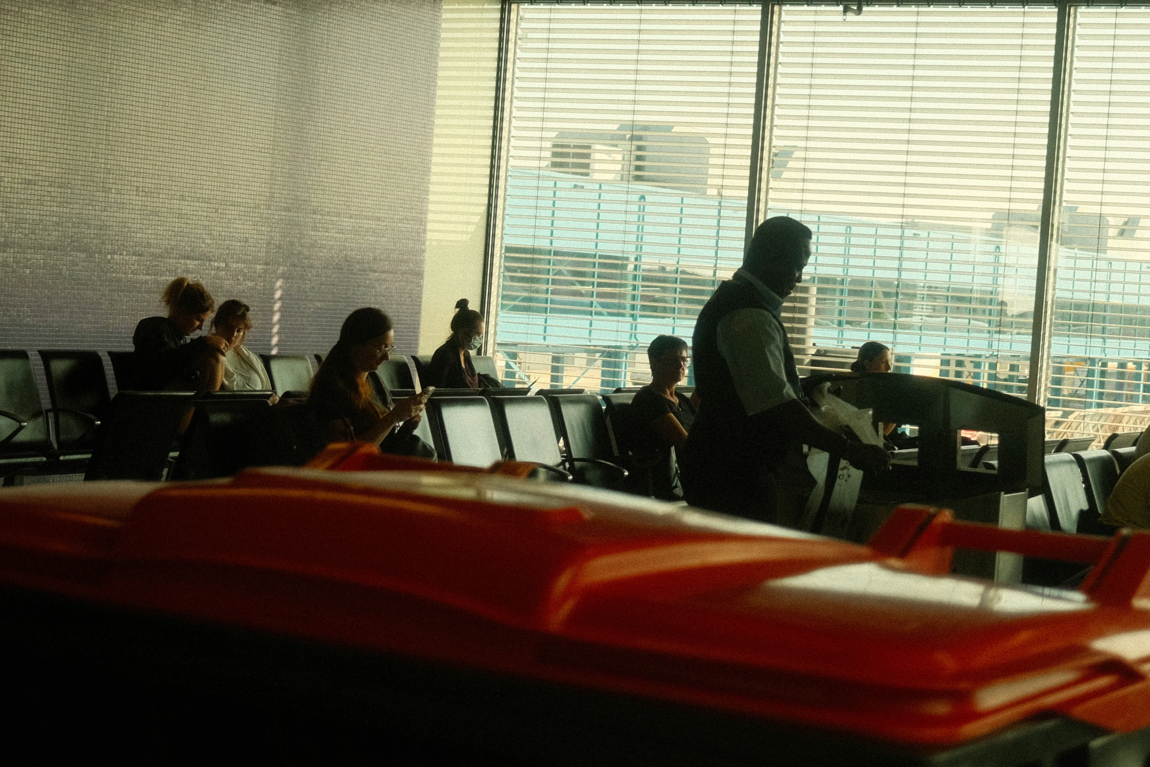 an airport with lots of people and one is getting his luggage