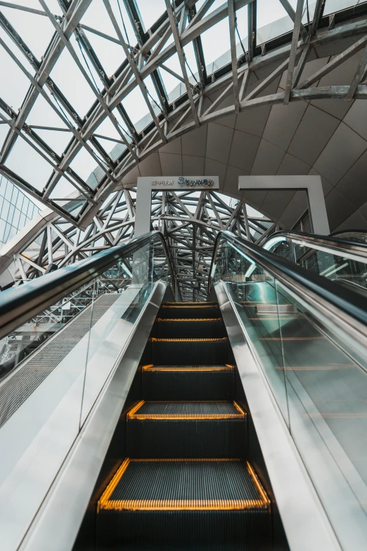 an escalator going up an esclotor in a subway