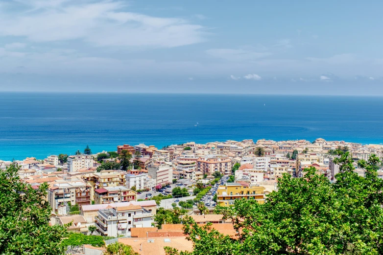 a city by the ocean on the horizon