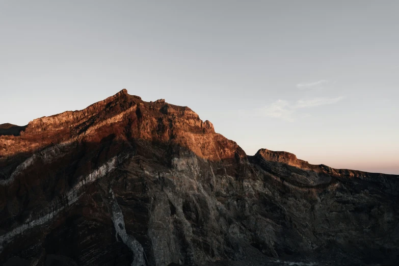 a large mountain peak sitting next to a body of water