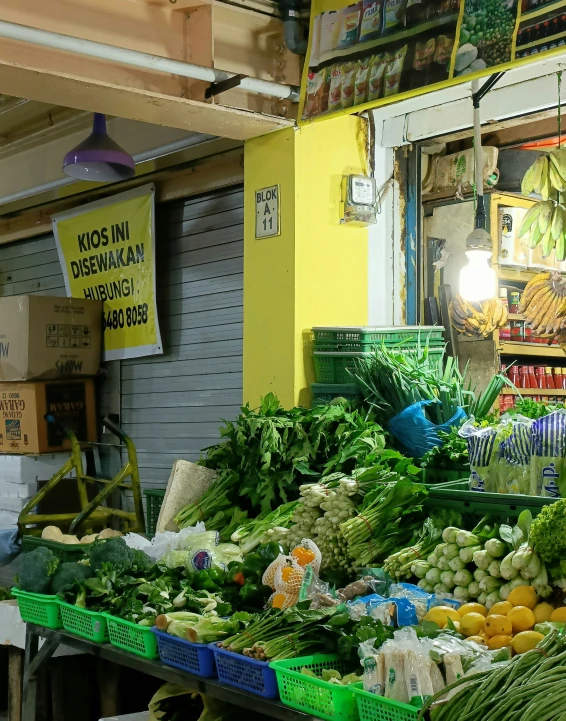 an indoor market is set up with vegetables and other produce