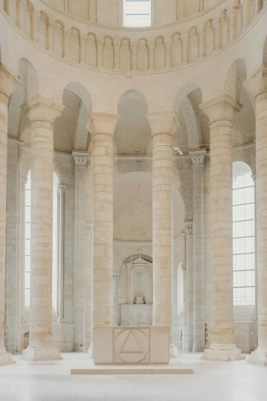 a room with columns, a fountain, and windows