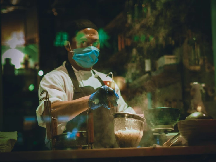 a man in a mask is cooking food