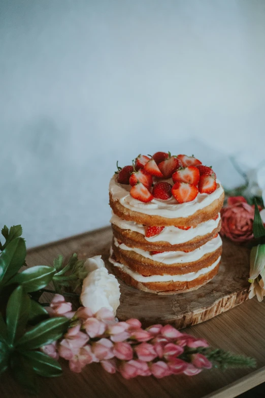 a large, layered cake sits on a wooden table