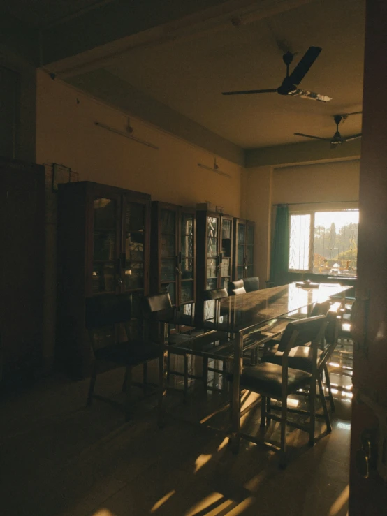 an empty living room with a dining table and chair