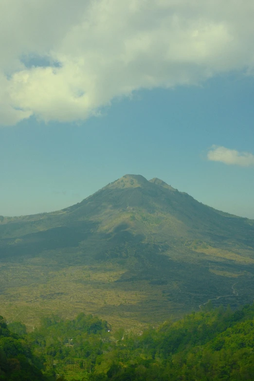 the mountain is in front of some clouds