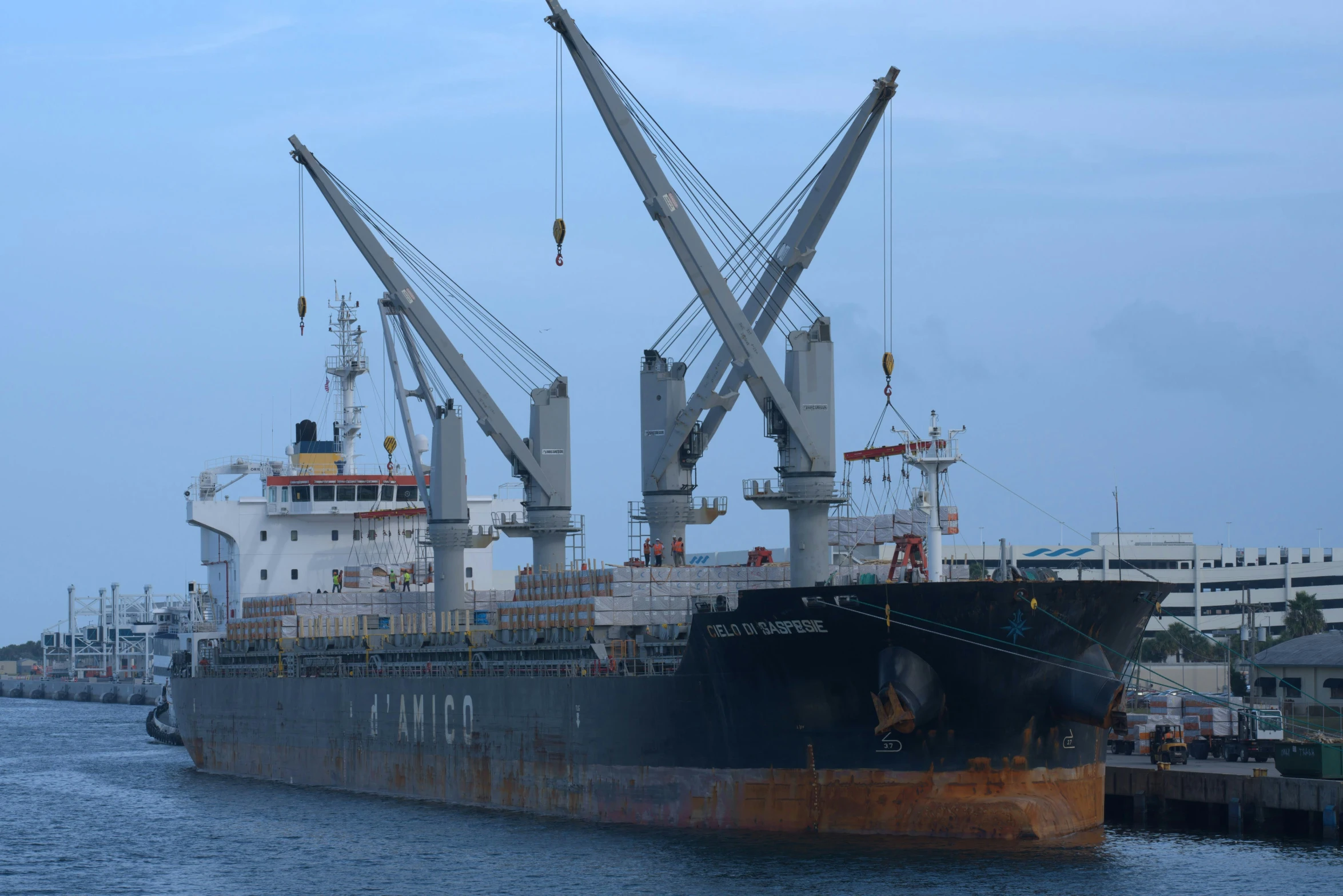 a large cargo ship docked in a bay