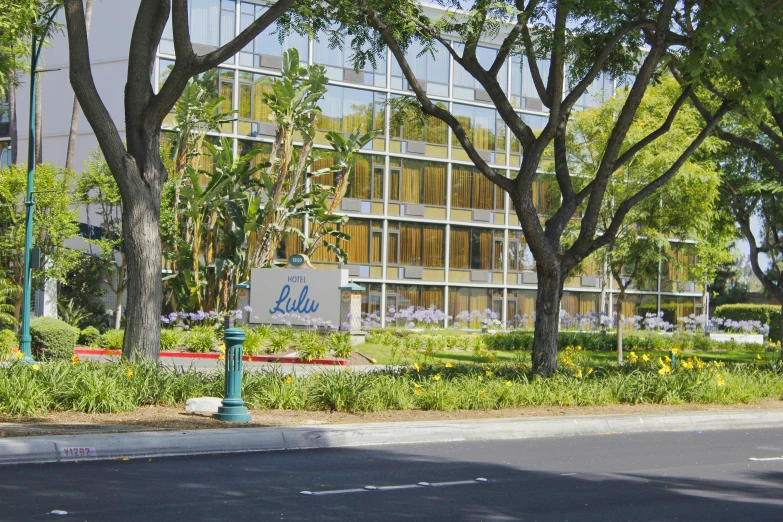 a building with tall trees on each side