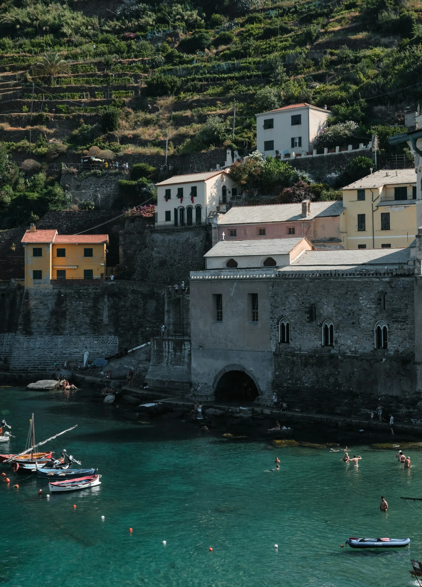 two boats floating on the water next to buildings