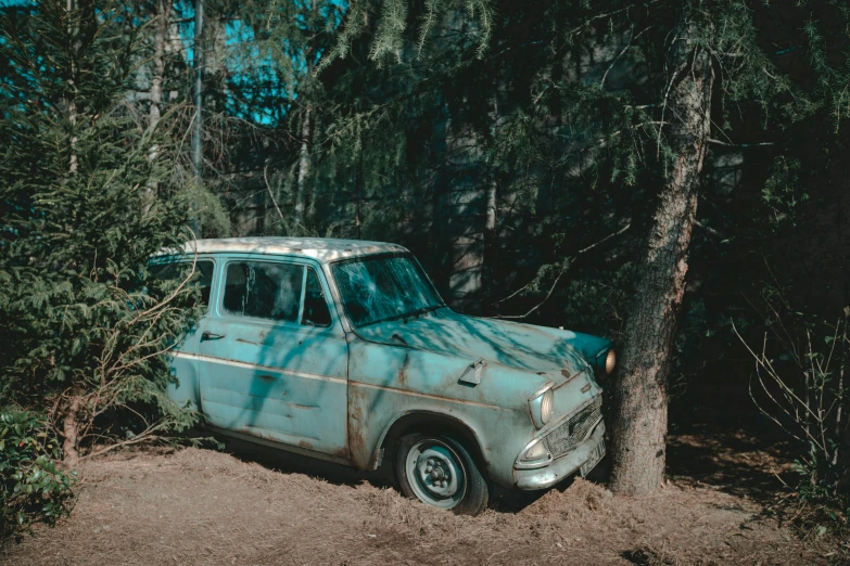 an old car in the woods with no passengers