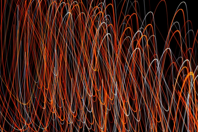 an abstract pograph of bright, orange and white strips of yarn