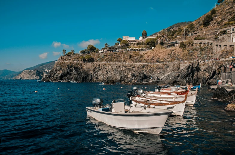 two boats docked next to one another in the ocean