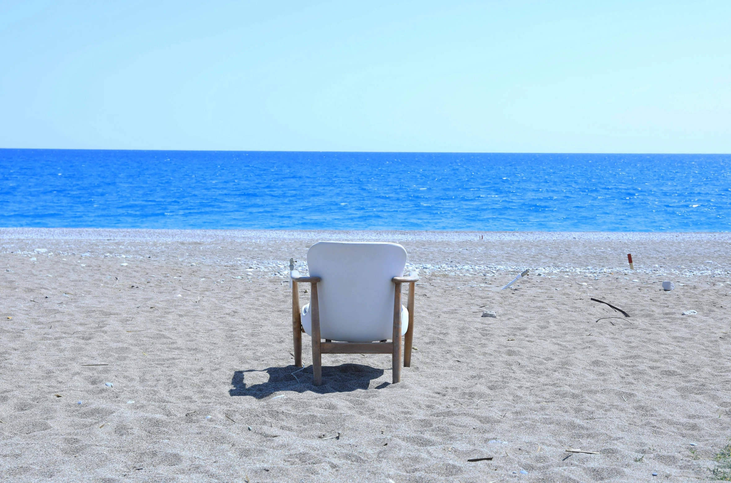 the chair is on the beach waiting for people to come in