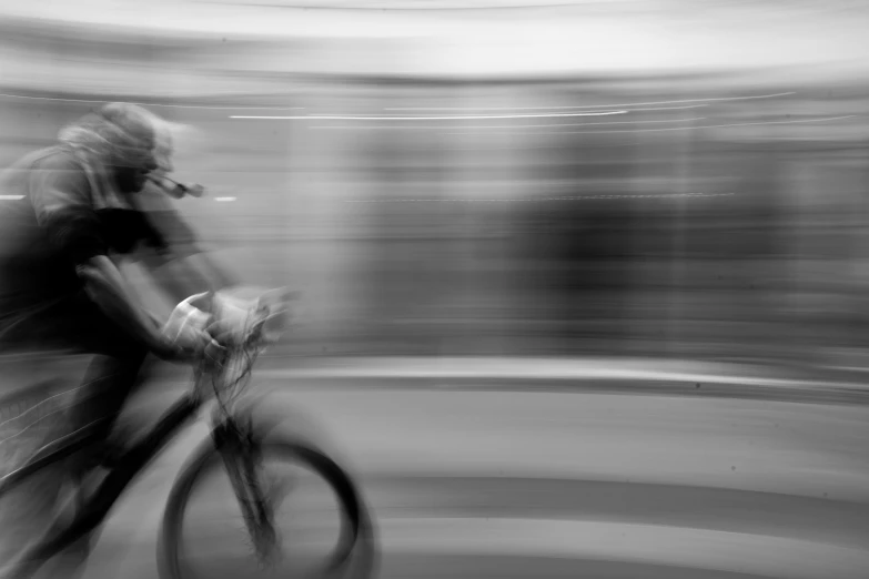 a blurry po of someone riding a bicycle in the night