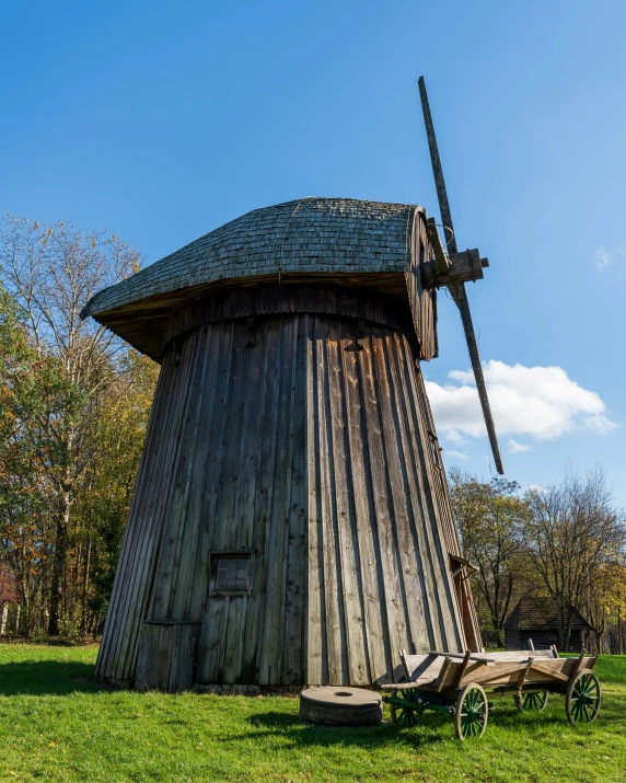 a wooden structure with a weather vane on top of it