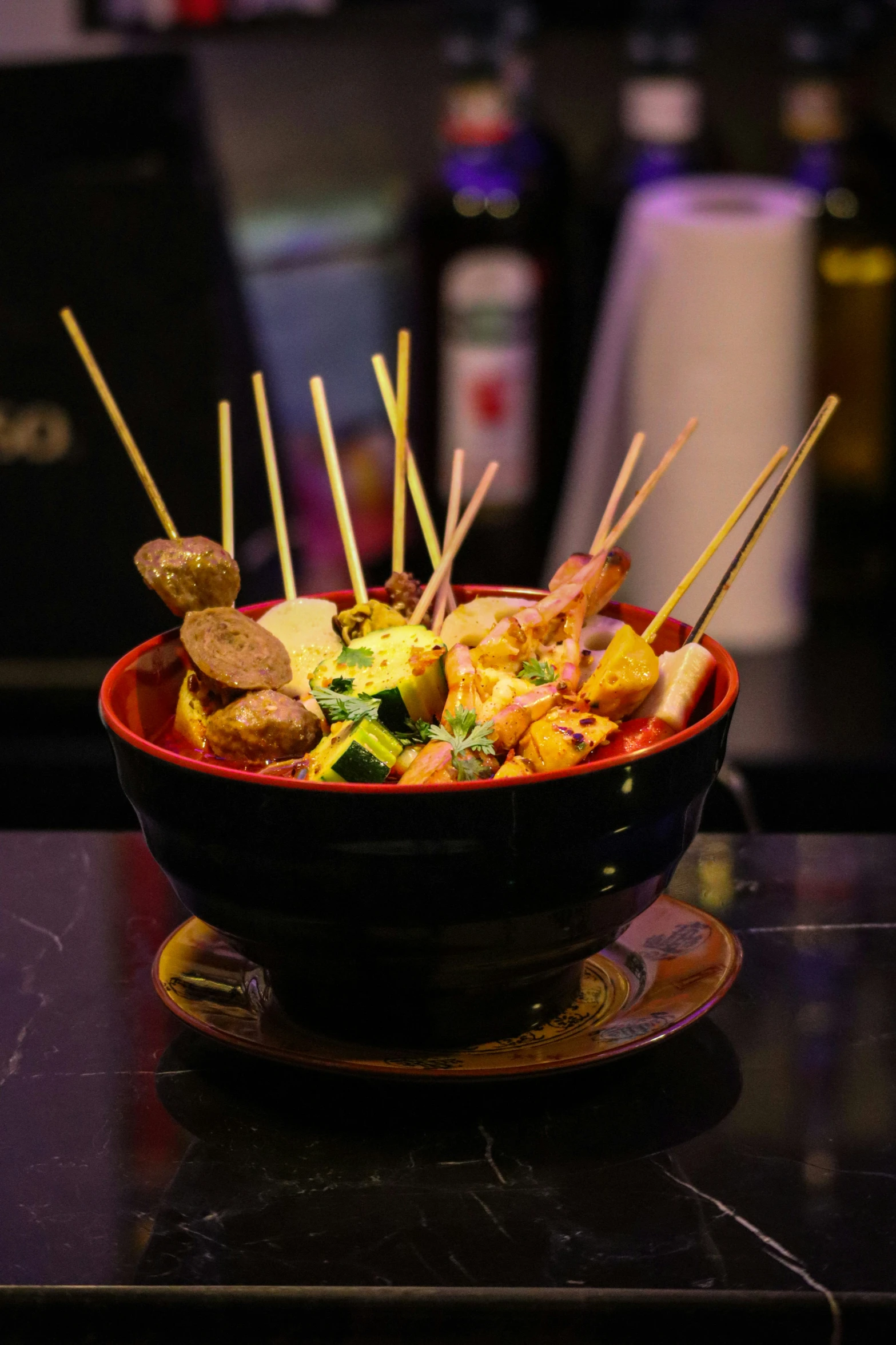 a bowl of food with skewered vegetables in it