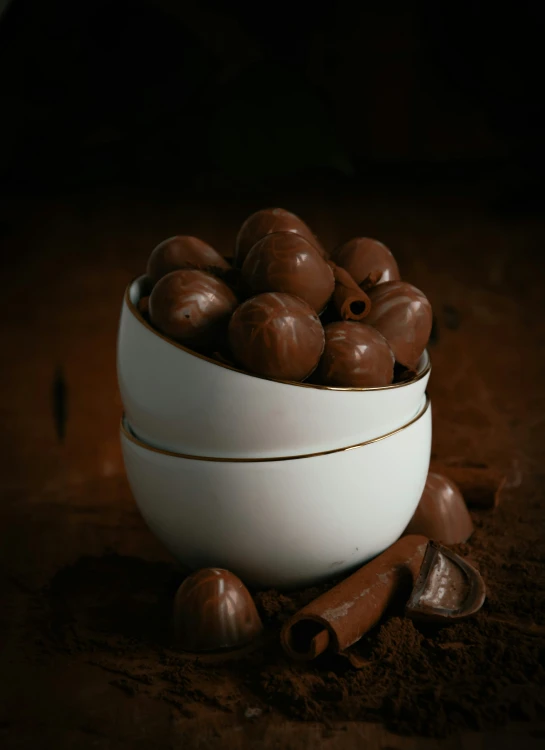 a bowl of chocolates are sitting in some dirt