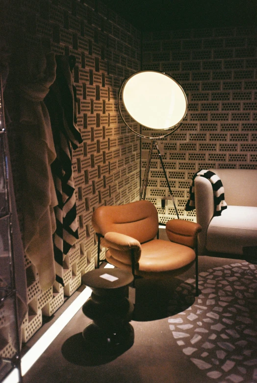 an interior po of a room with a chair, rug, light and bed