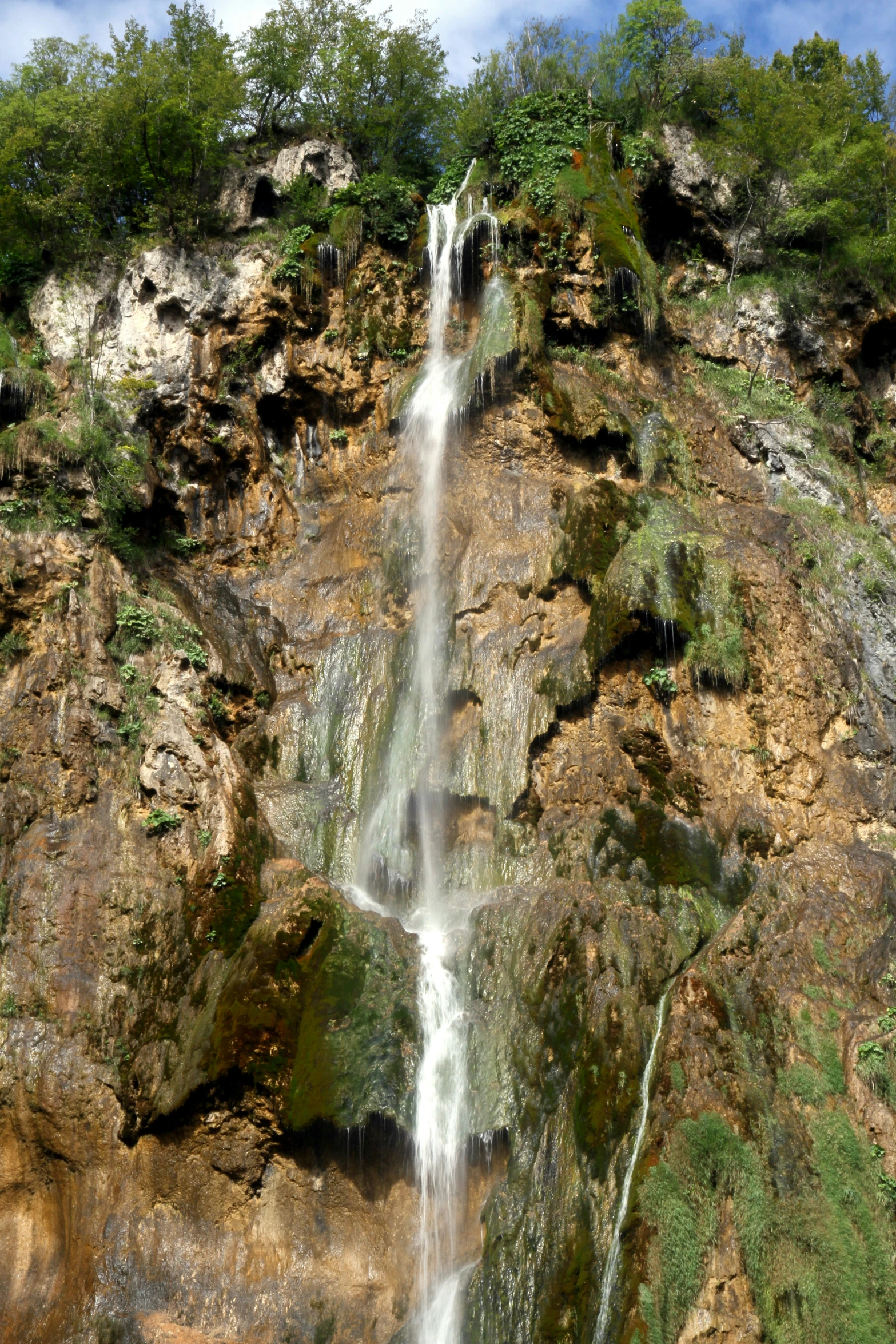 a waterfall is seen from the top of the cliff