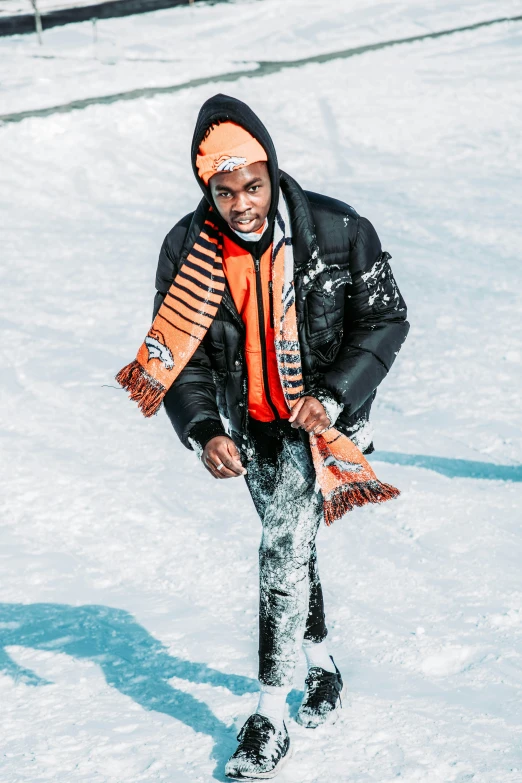 an individual stands in the snow on a sunny day