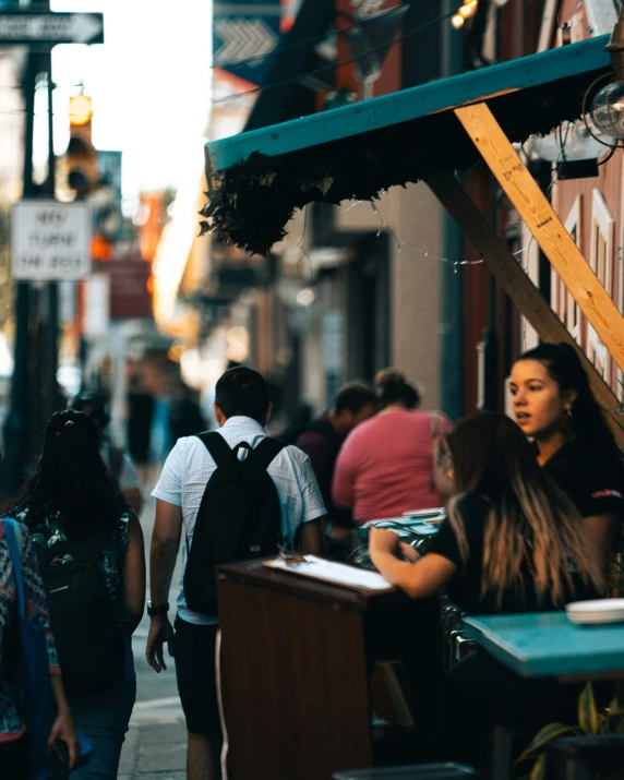 a group of people are walking down the street