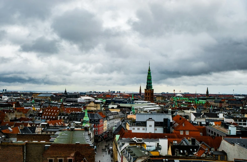 a view from above, a city, with steeple towering over the surrounding buildings