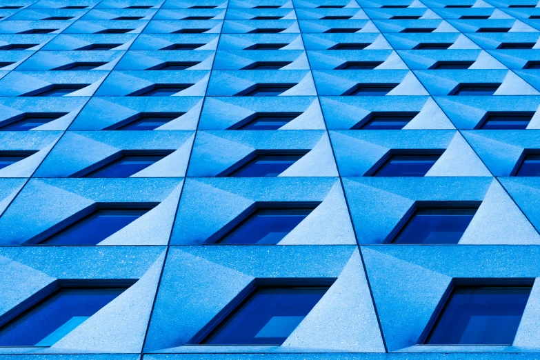 an exterior view of a building with windows showing diagonal grids