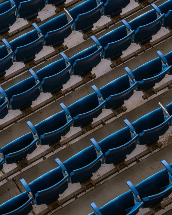 blue seats are lined up in the stadium