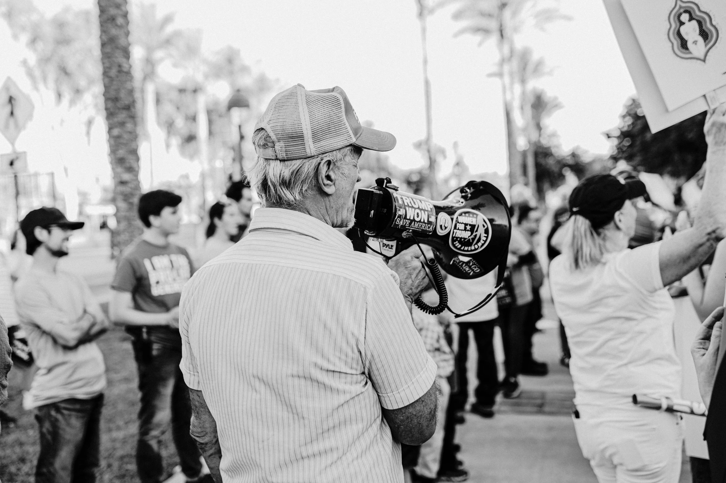 a man with a camera in his hand on the side walk