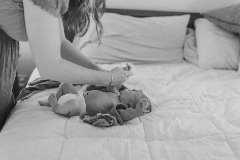 woman sitting on bed with small stuffed animals