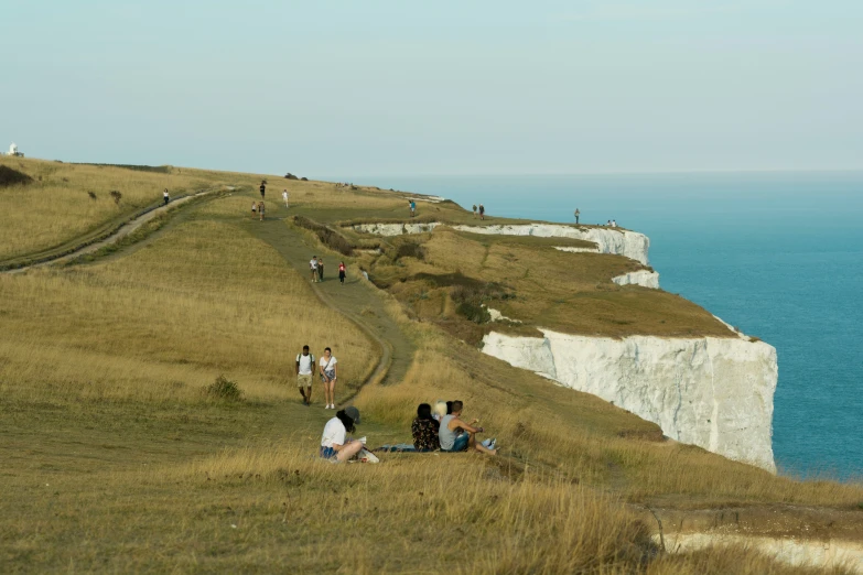 some people are walking up the side of a hill