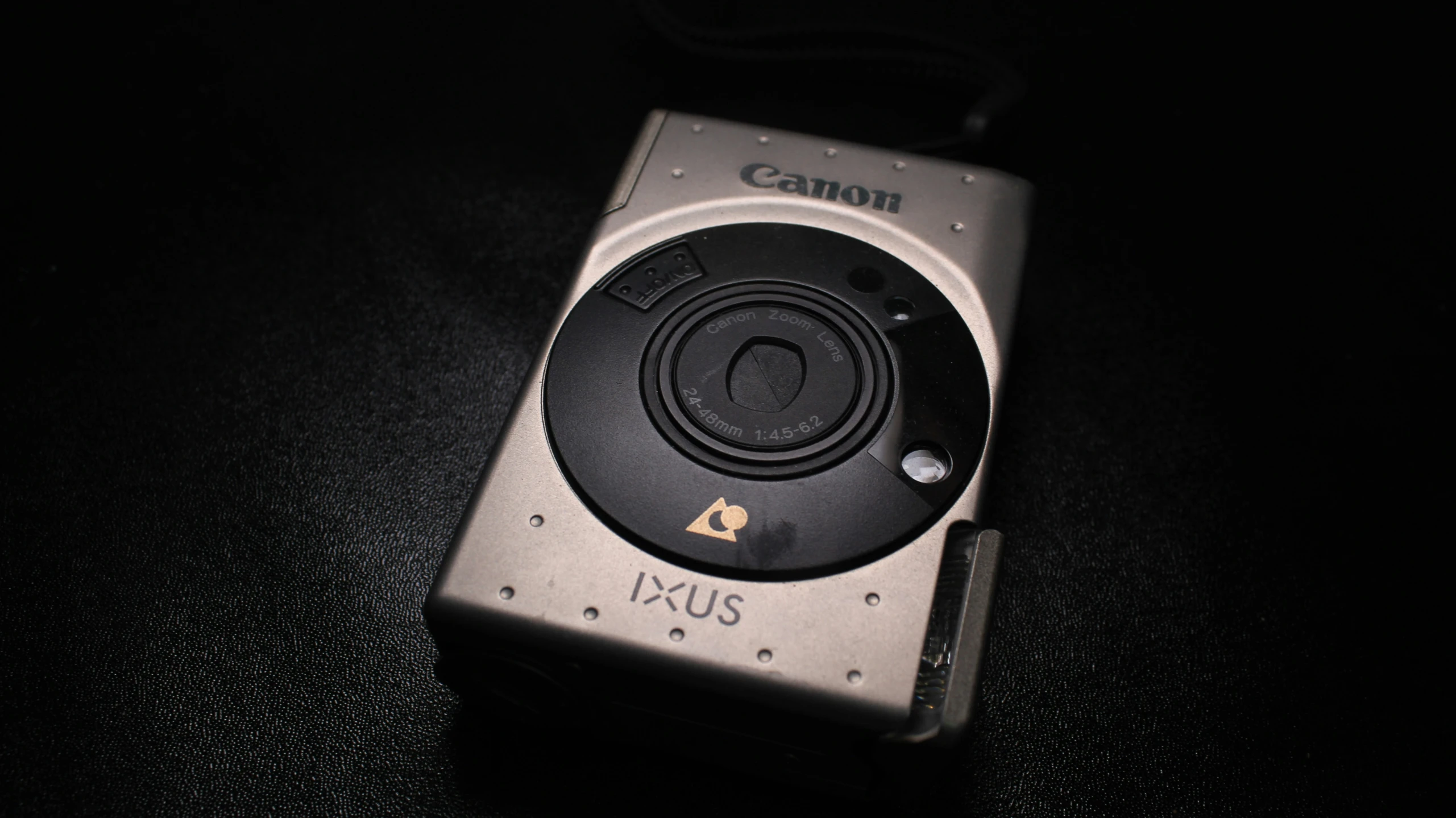 a small digital camera sitting on top of a black counter