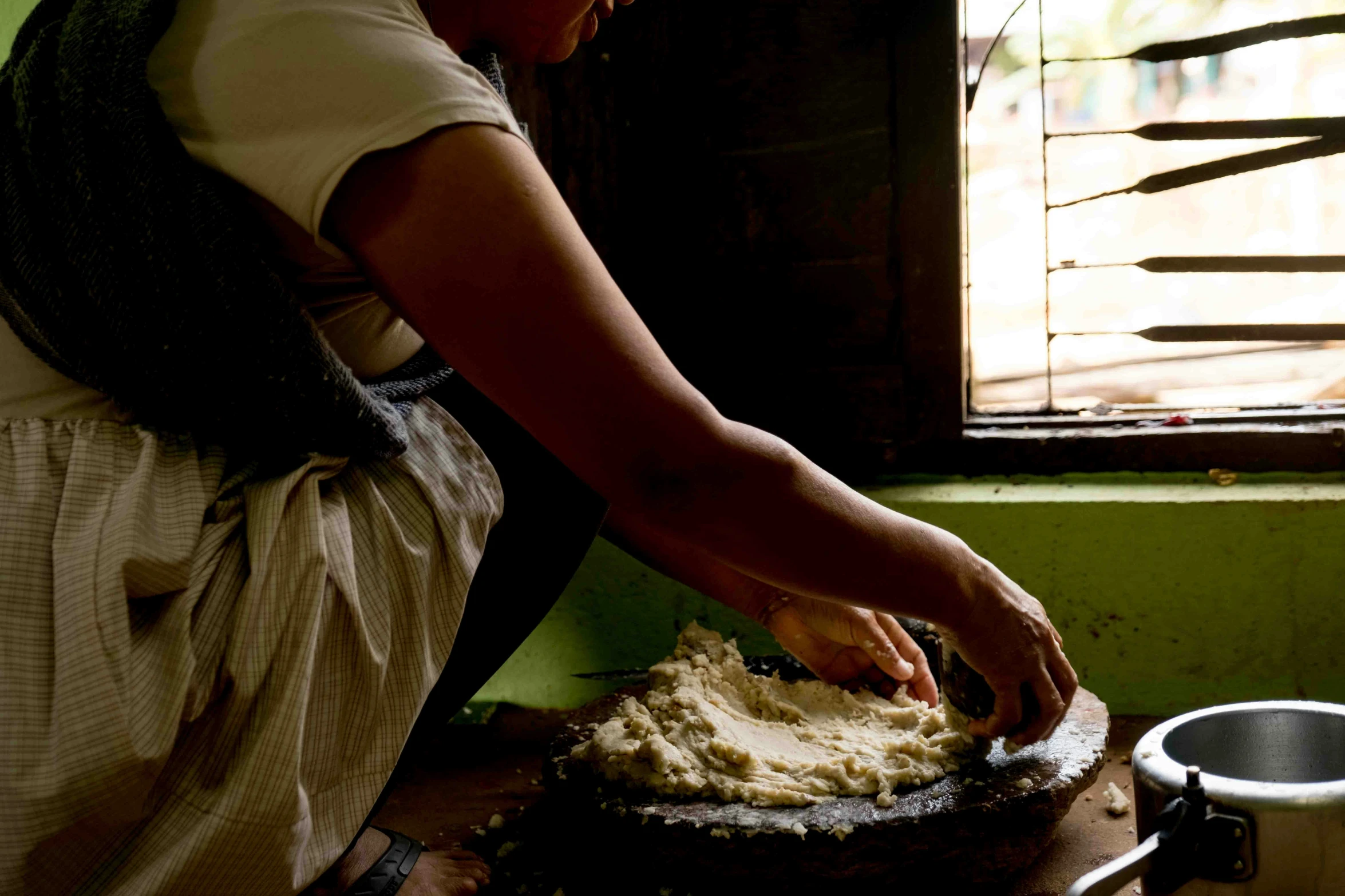 a woman in aprons making soing on a table