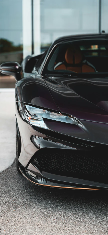 black sports car parked in front of a building