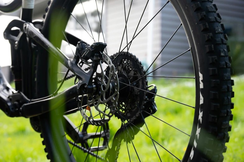 the rear wheel of a bike in a grassy field