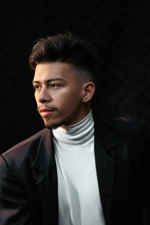 a man with a white turtleneck and suit looking into the distance