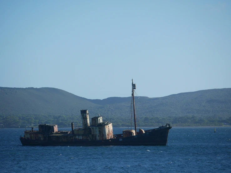 an old ship is out in the open ocean