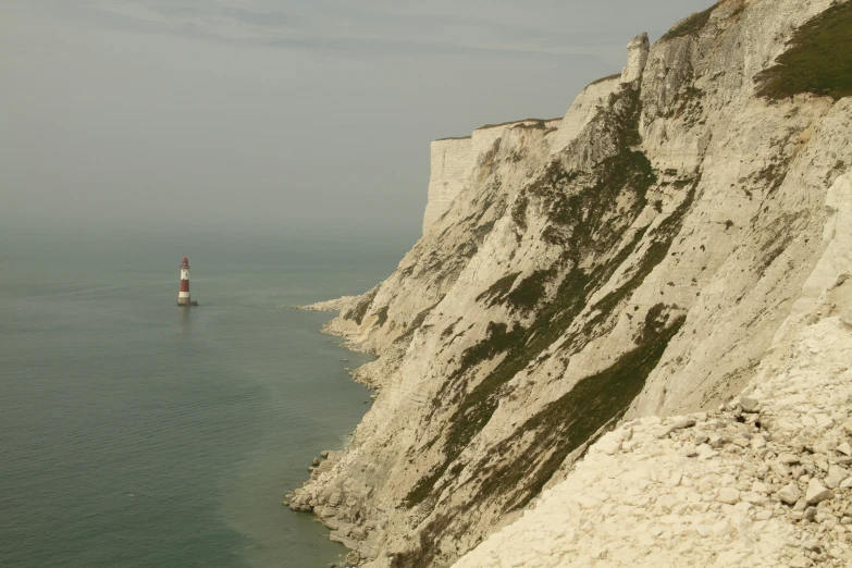 two lighthouses on the top of two tall white cliffs