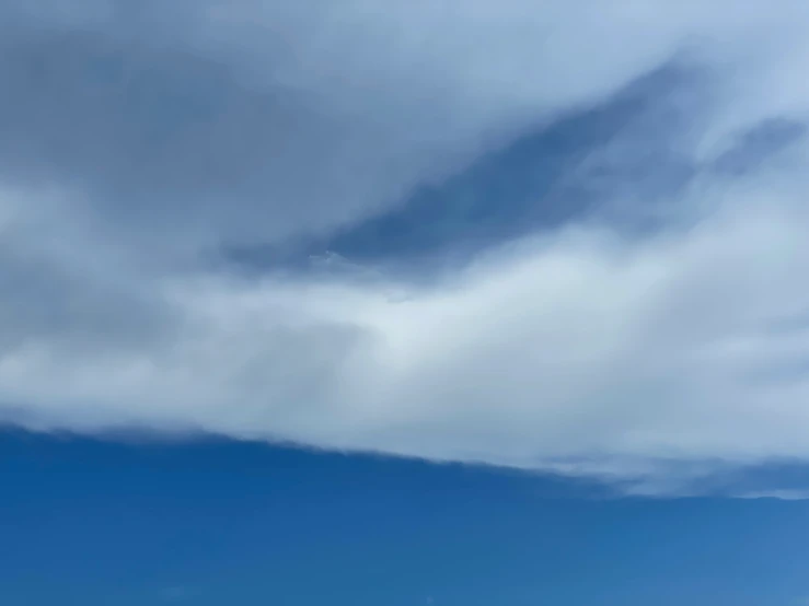 the man is taking a picture in front of the ocean