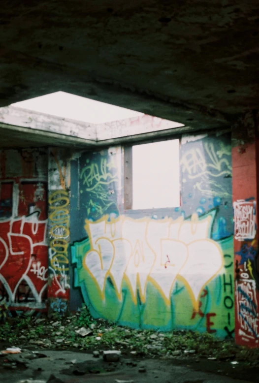 graffiti written on a wall in an empty building