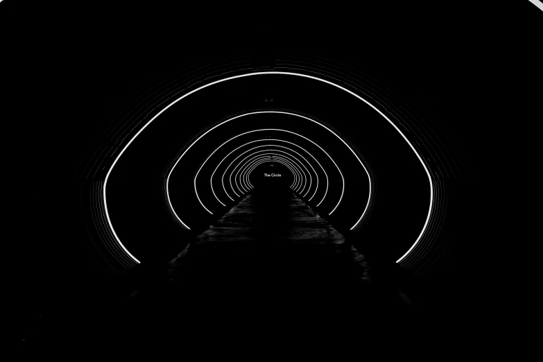 this black and white image shows the inside of a tunnel