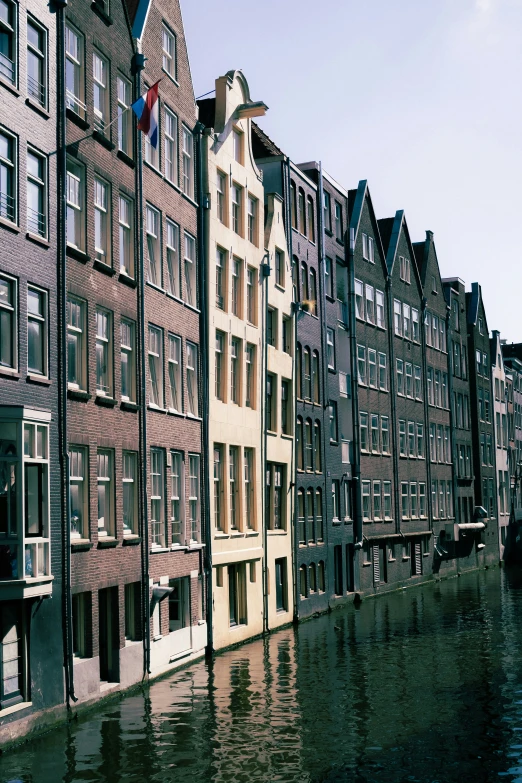 a waterway is lined with row houses in the city