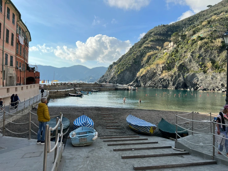 several boats parked near the shore in front of some buildings