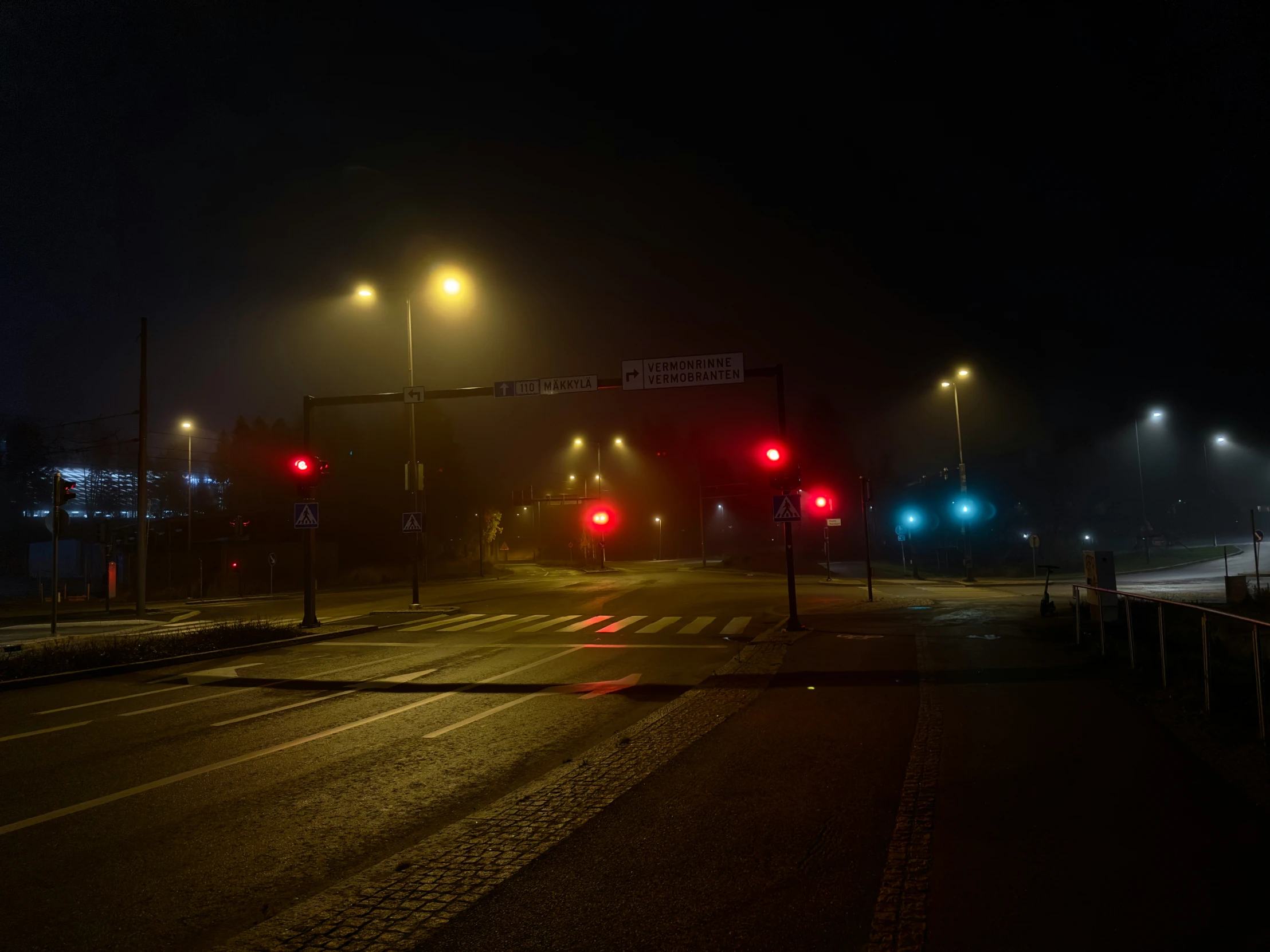 an empty street that has many red lights on it