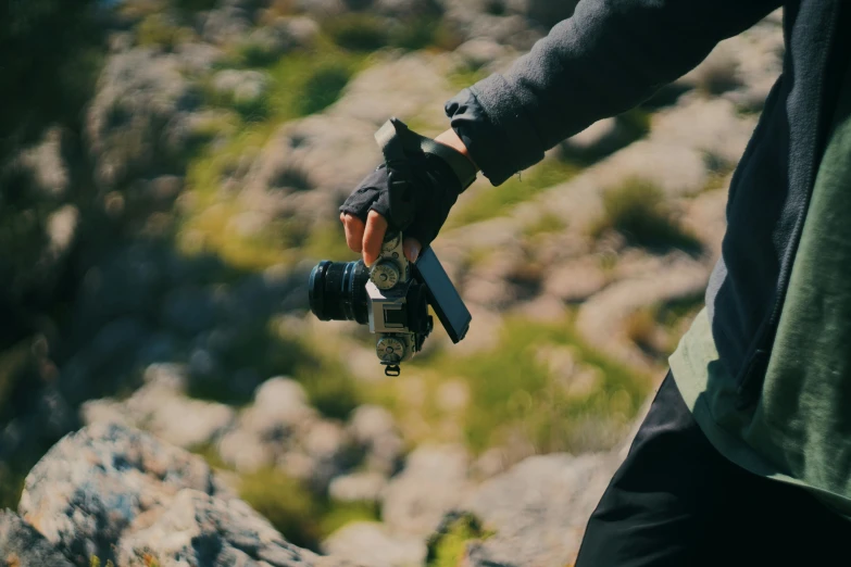 a person taking a po with a camera in the rocky area