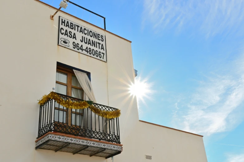 a balcony above an empty street with a sign