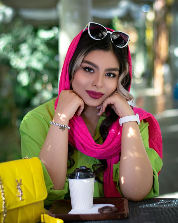 an indian woman sits at a table with her eyes closed