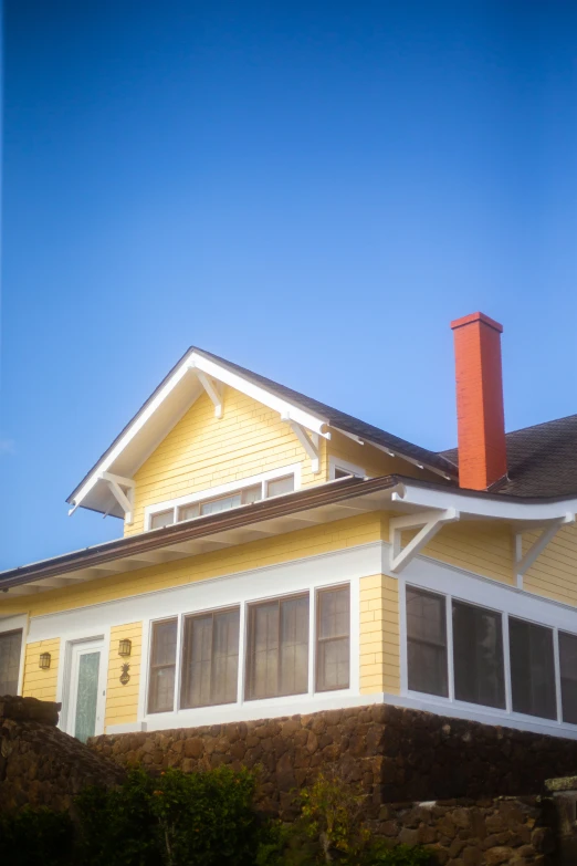 the outside view of a yellow home with white trim