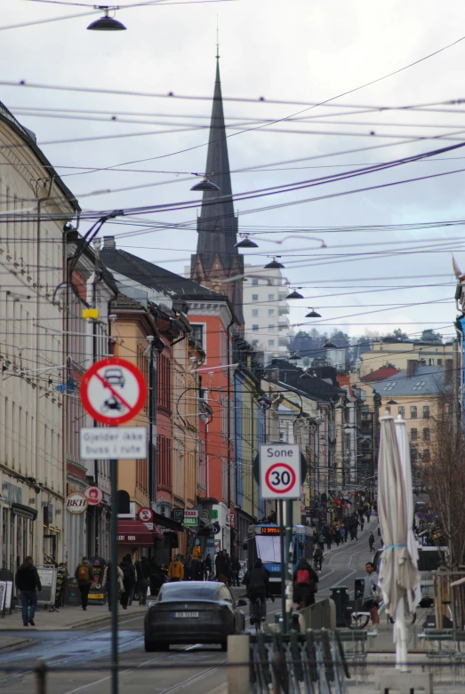 many people walking on the streets of city with cars