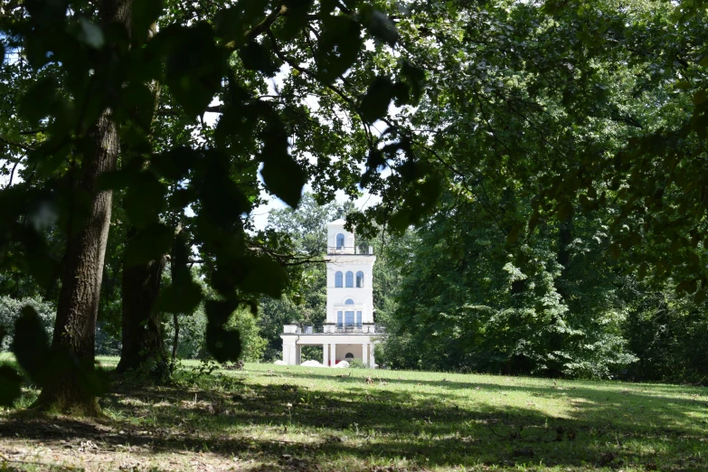 a house is seen through the trees in a yard